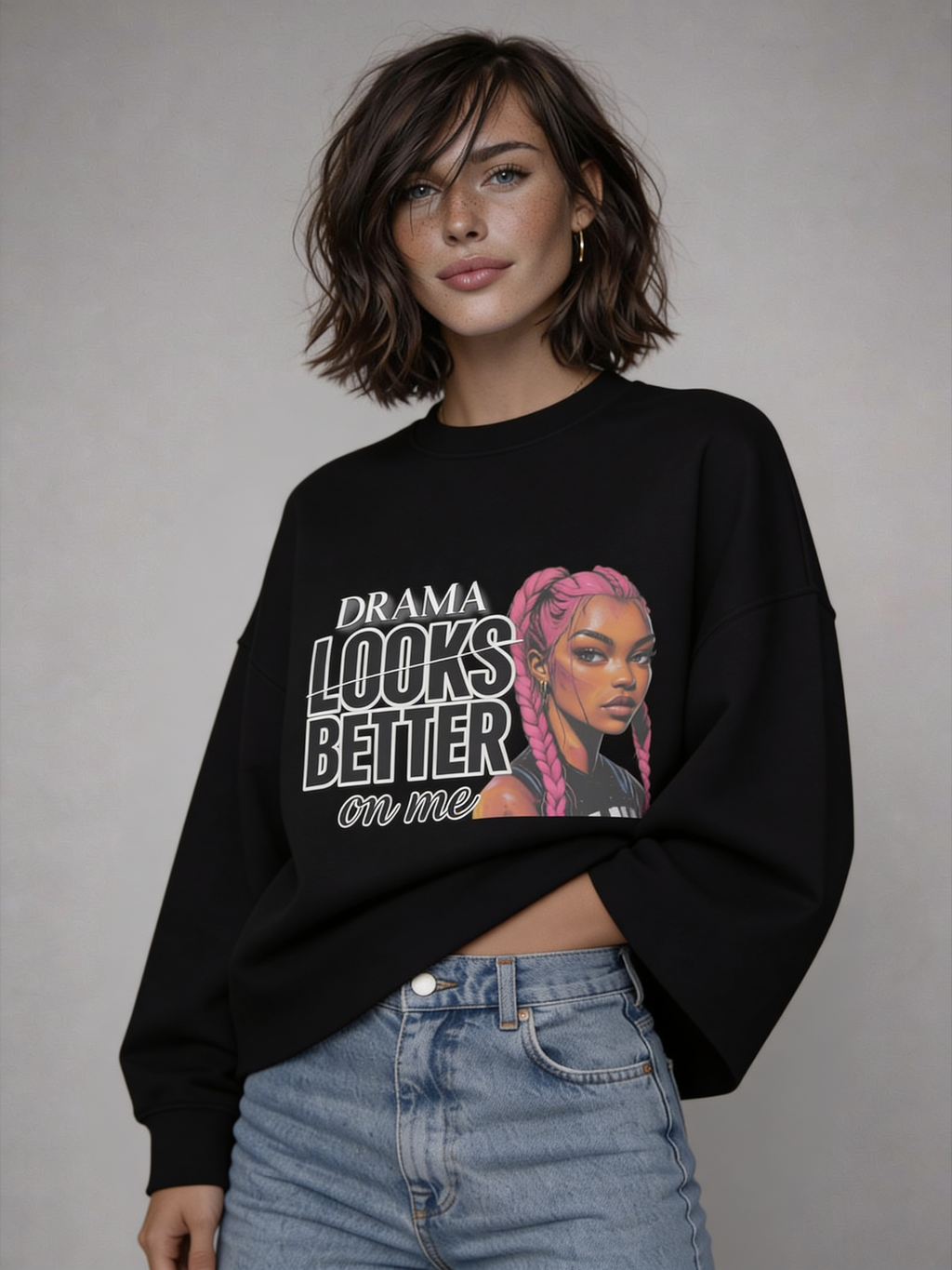 Black oversized sweatshirt with “DRAMA LOOKS BETTER ON ME” graphic showing front and back print with pink braided illustration,  studio image.