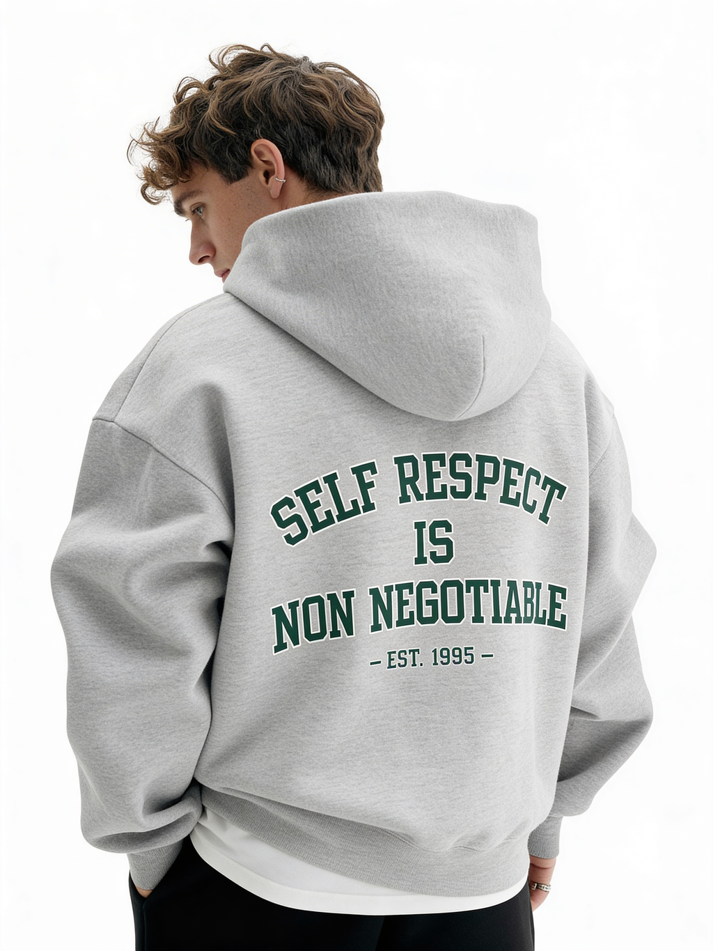Grey oversized hoodie back view on male model featuring green “Self Respect Is Non Negotiable – EST. 1995” statement print