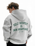 Grey oversized hoodie back view on male model featuring green “Self Respect Is Non Negotiable – EST. 1995” statement print