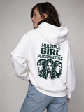 Female model wearing oversized white hoodie featuring “Multiple Girl Personalities” back print graphic, styled with blue denim jeans, women’s streetwear fashion photography.
