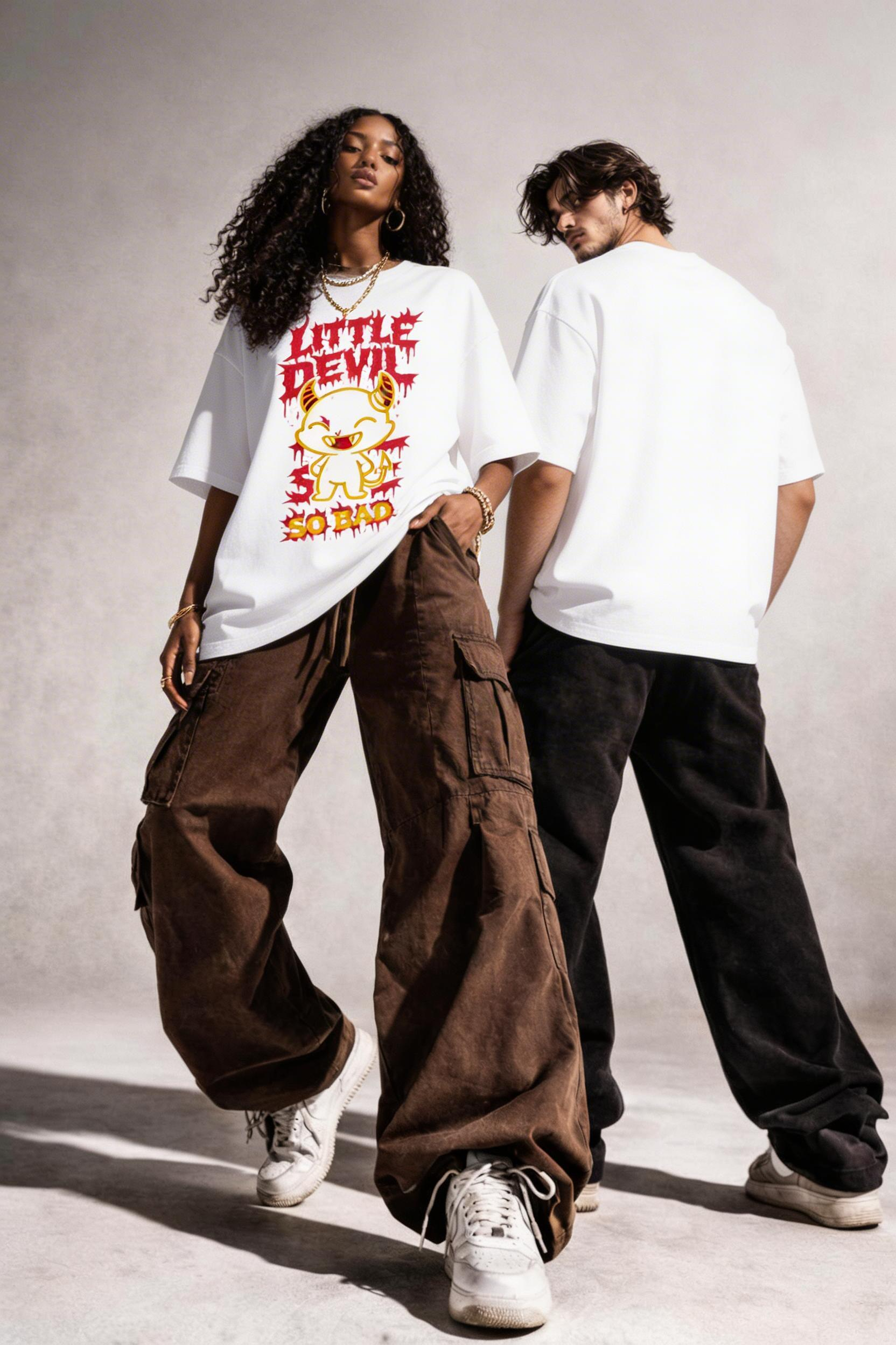 Male and female models wearing oversized white streetwear graphic t shirt with Little Devil So Bad cartoon devil illustration