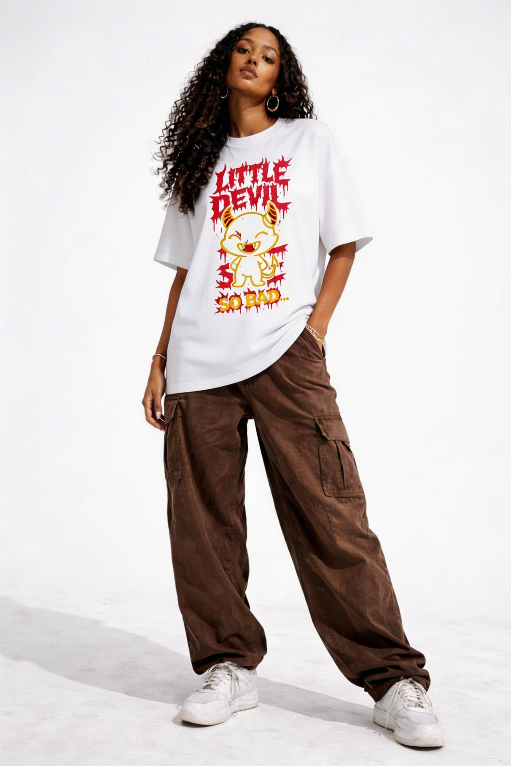 Female model wearing oversized white streetwear graphic t shirt featuring Little Devil So Bad cartoon graphic design