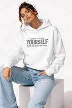 female model sitting pose wearing oversized white graphic hoodie compare yourself motivational design urban streetwear outfit