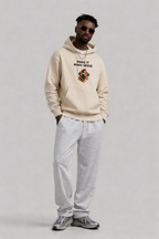 male model standing front view wearing oversized beige hoodie make it make sense graphic cube design streetwear style