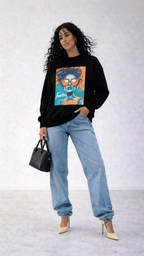 female model side pose wearing black oversized graphic sweatshirt fearless design urban streetwear outfit with heels and denim