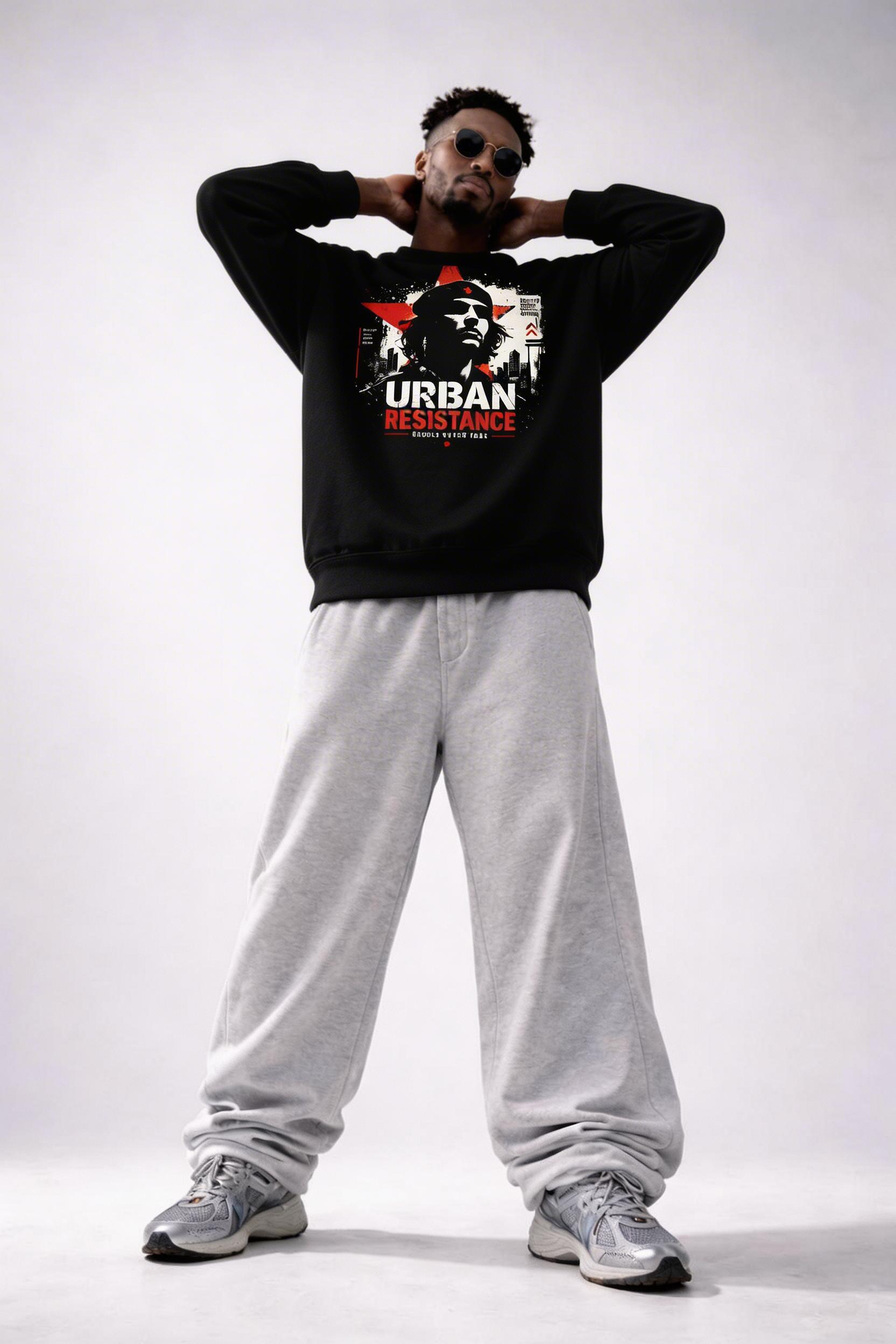 male model standing hands behind head wearing black oversized graphic sweatshirt urban resistance design relaxed streetwear style