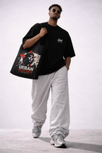 male model side view carrying black tote bag urban resistance artwork urban streetwear look
