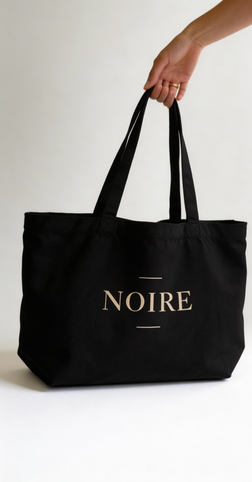 black oversized eco tote bag front view product mockup NOIRE logo minimal streetwear canvas tote bag