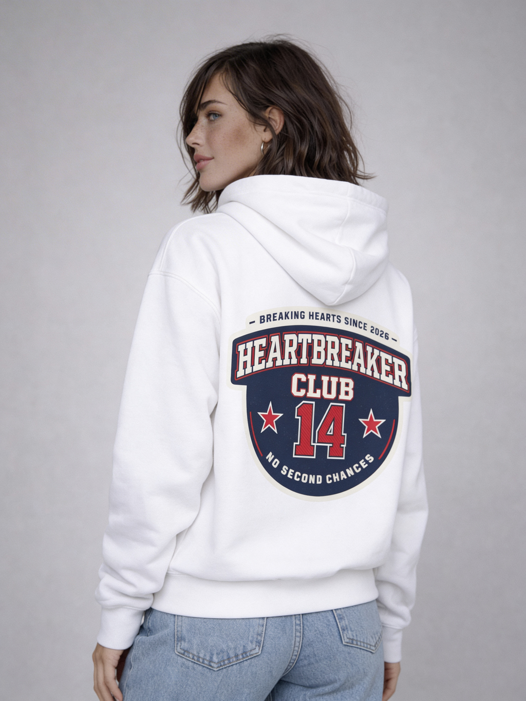 Noiré white oversized hoodie back view with “Heartbreaker Club 14” varsity graphic print in red and navy, worn by female model, streetwear Valentine collection.