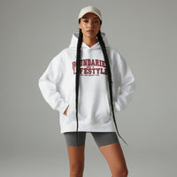 Model wearing white unisex hoodie with “Boundaries Are a Lifestyle” text design in a clean studio setting