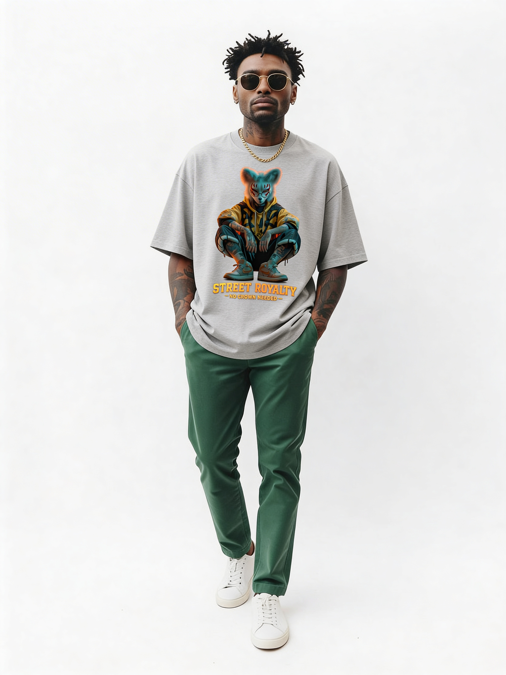 Grey oversized streetwear t-shirt with “Street Royalty – No Crown Needed” graphic worn by male model walking in studio, contemporary urban style, relaxed fit streetwear look.