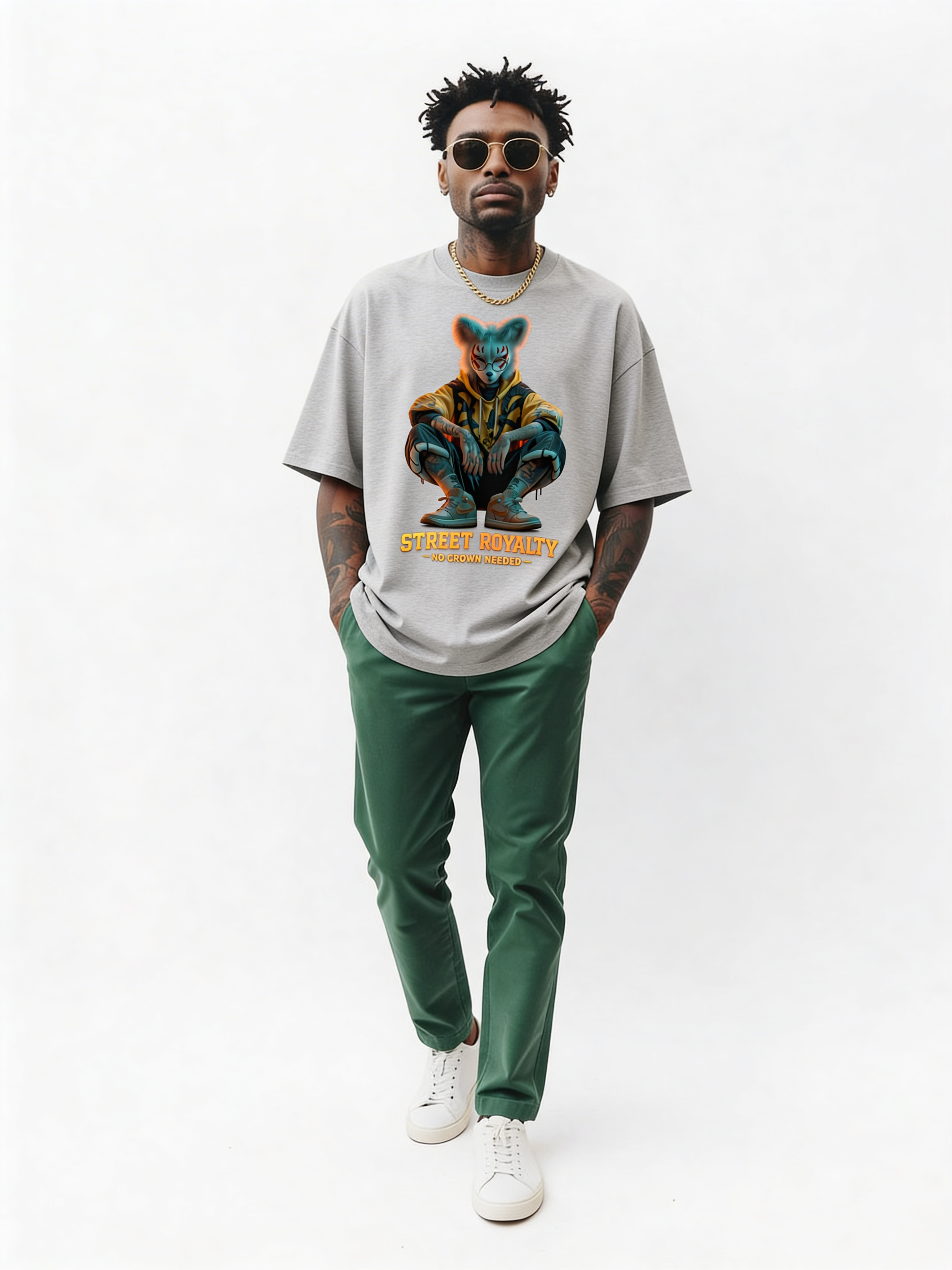 Grey oversized streetwear t-shirt with “Street Royalty – No Crown Needed” graphic worn by male model walking in studio, contemporary urban style, relaxed fit streetwear look.