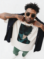 Male fashion model wearing oversized white streetwear t-shirt with anime-inspired portrait graphic, layered with dark jacket and gold chain, contemporary urban style studio shot