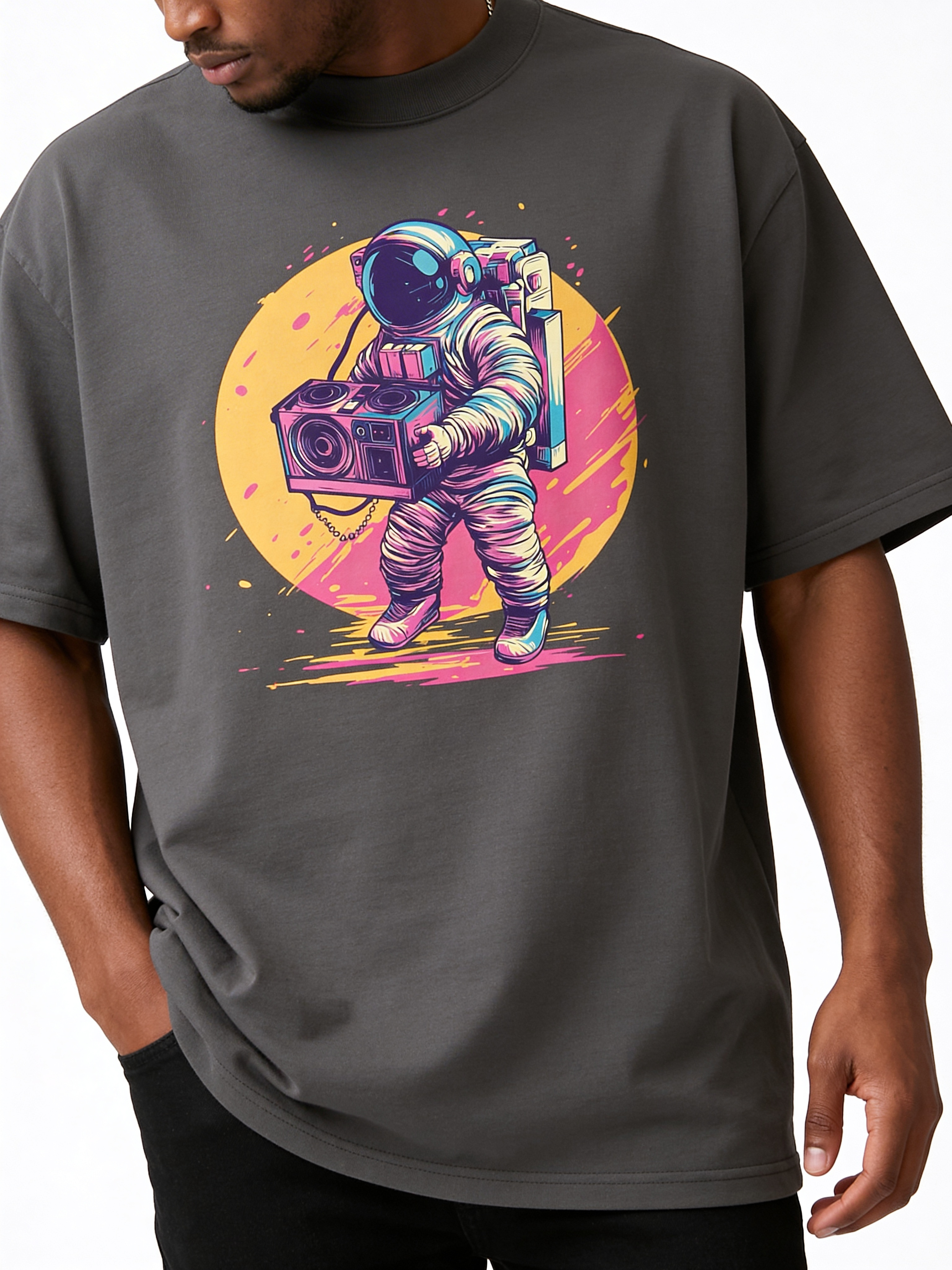 Close-up of oversized charcoal grey graphic tee featuring vibrant astronaut with boombox illustration, men’s contemporary streetwear design detail