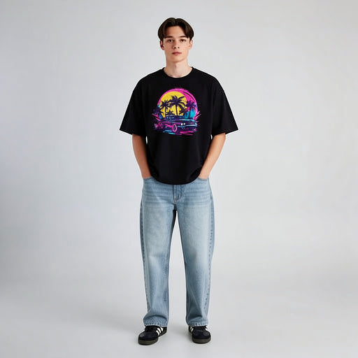 Full body model wearing black unisex graphic t-shirt with retro sunset palm tree graphic, contemporary streetwear outfit