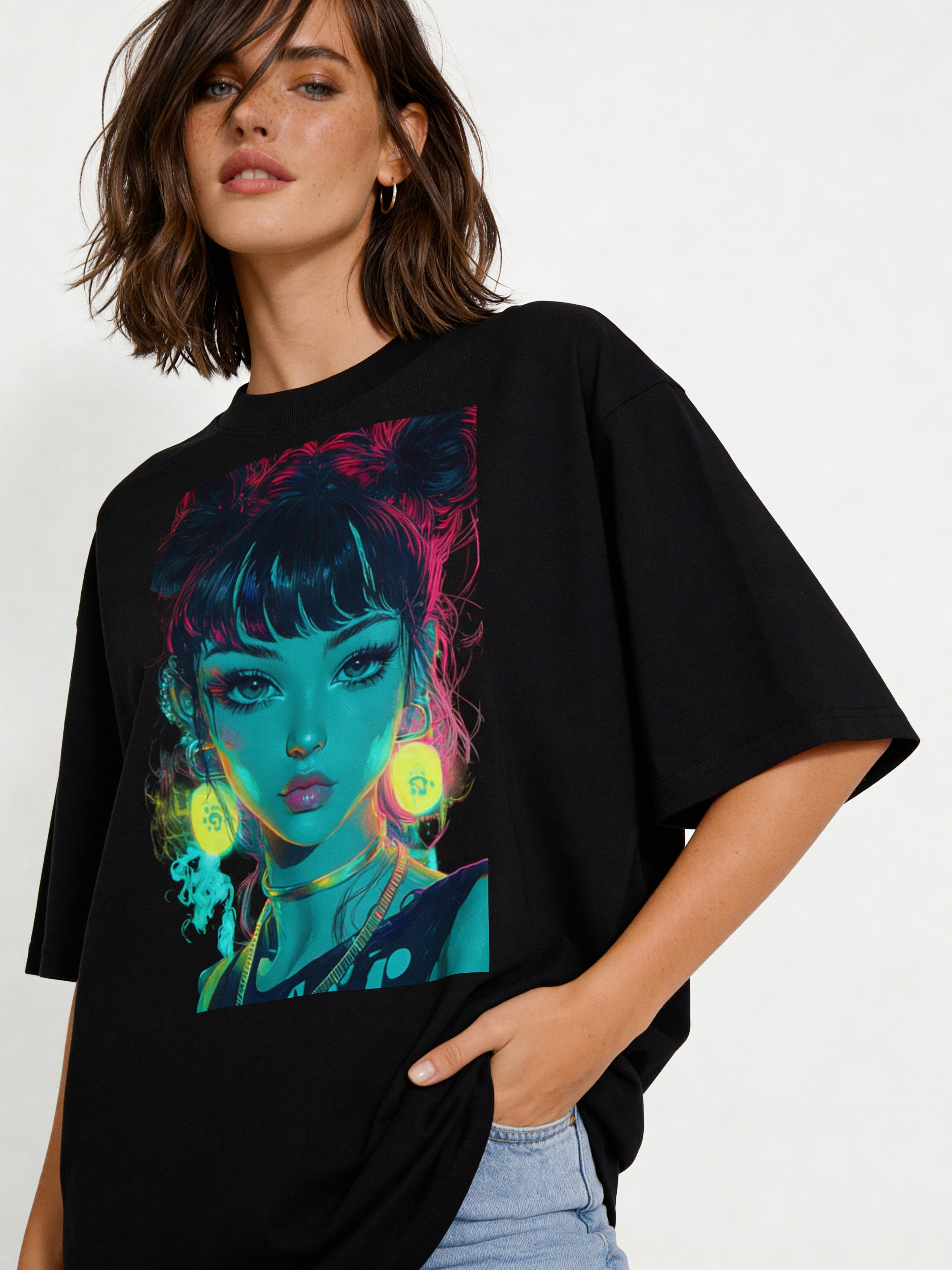 Female model wearing oversized black graphic t-shirt featuring neon cyberpunk girl portrait with glowing earrings and vibrant blue and pink tones, modern streetwear style