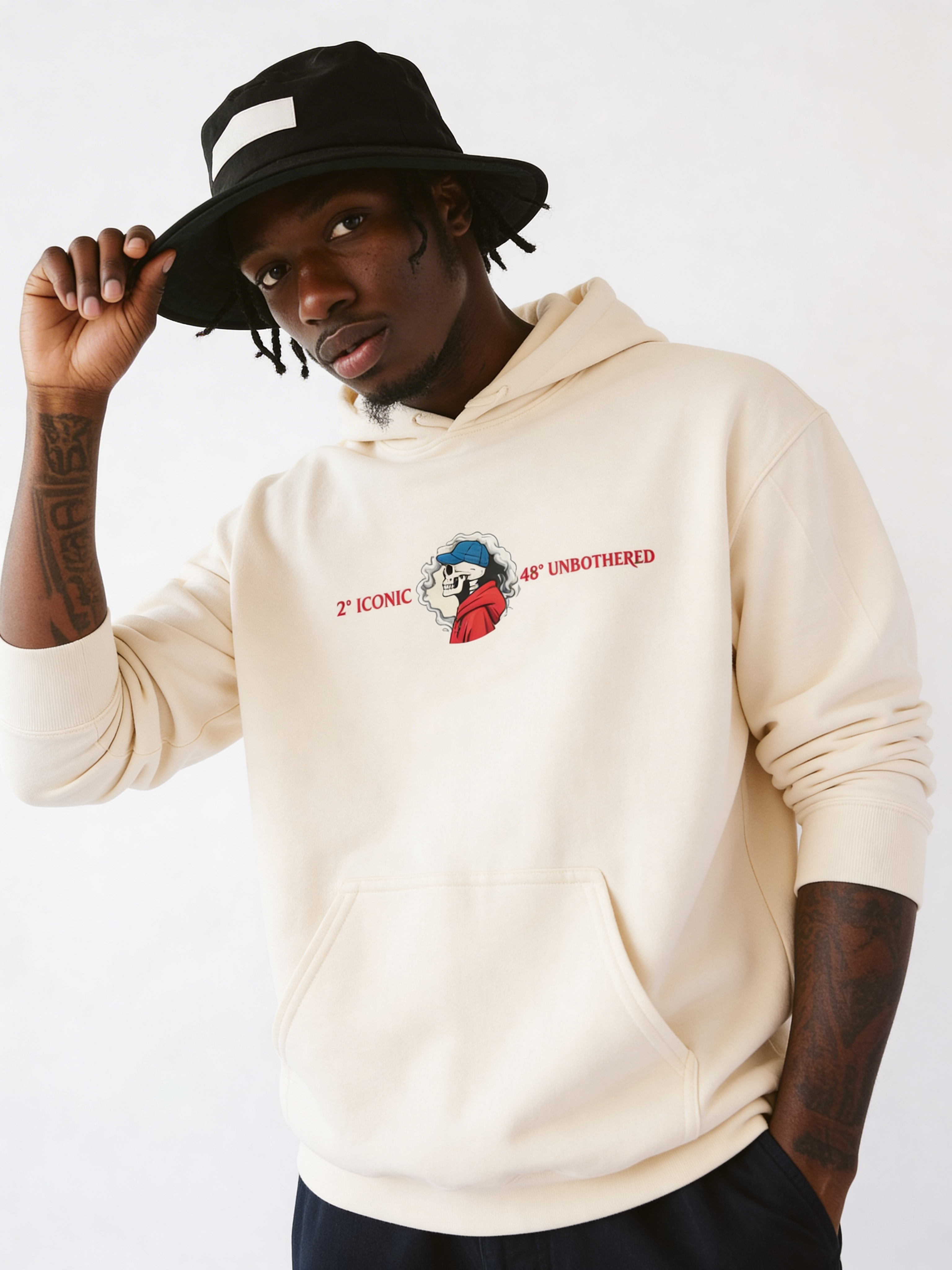 Male model modeling beige oversized graphic hoodie with minimal chest print, relaxed urban fashion style