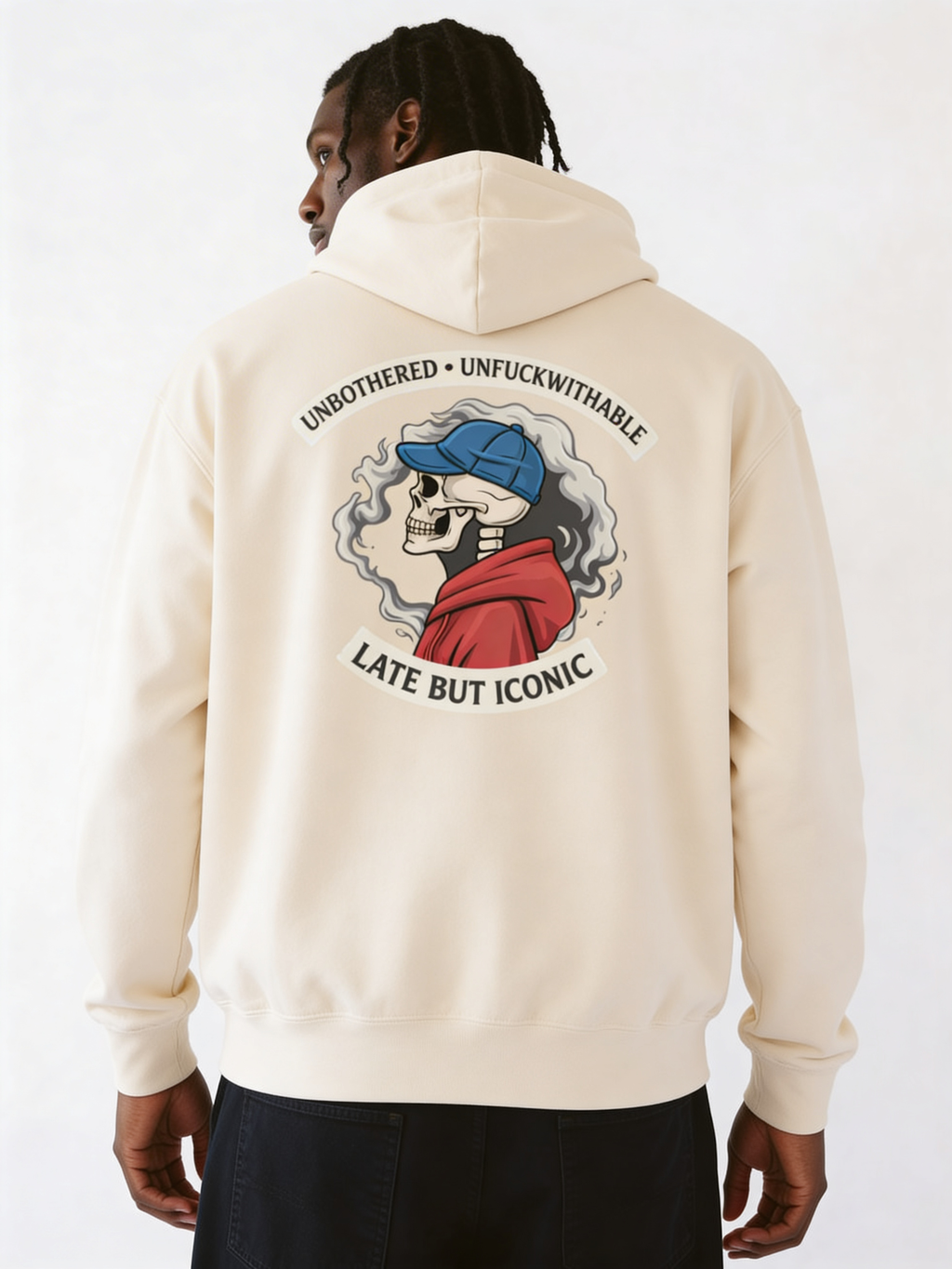 Male model wearing cream oversized streetwear hoodie with large illustrated back graphic and bold emblem design