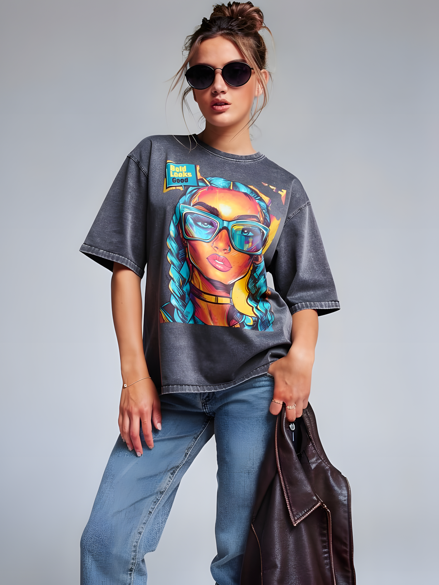 Model wearing unisex denim graphic t-shirt with colorful pop art portrait design in a studio setting