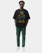 Black oversized streetwear t-shirt with “Street Royalty – No Crown Needed” fox character graphic worn by male model, urban minimalist studio background, modern street fashion.