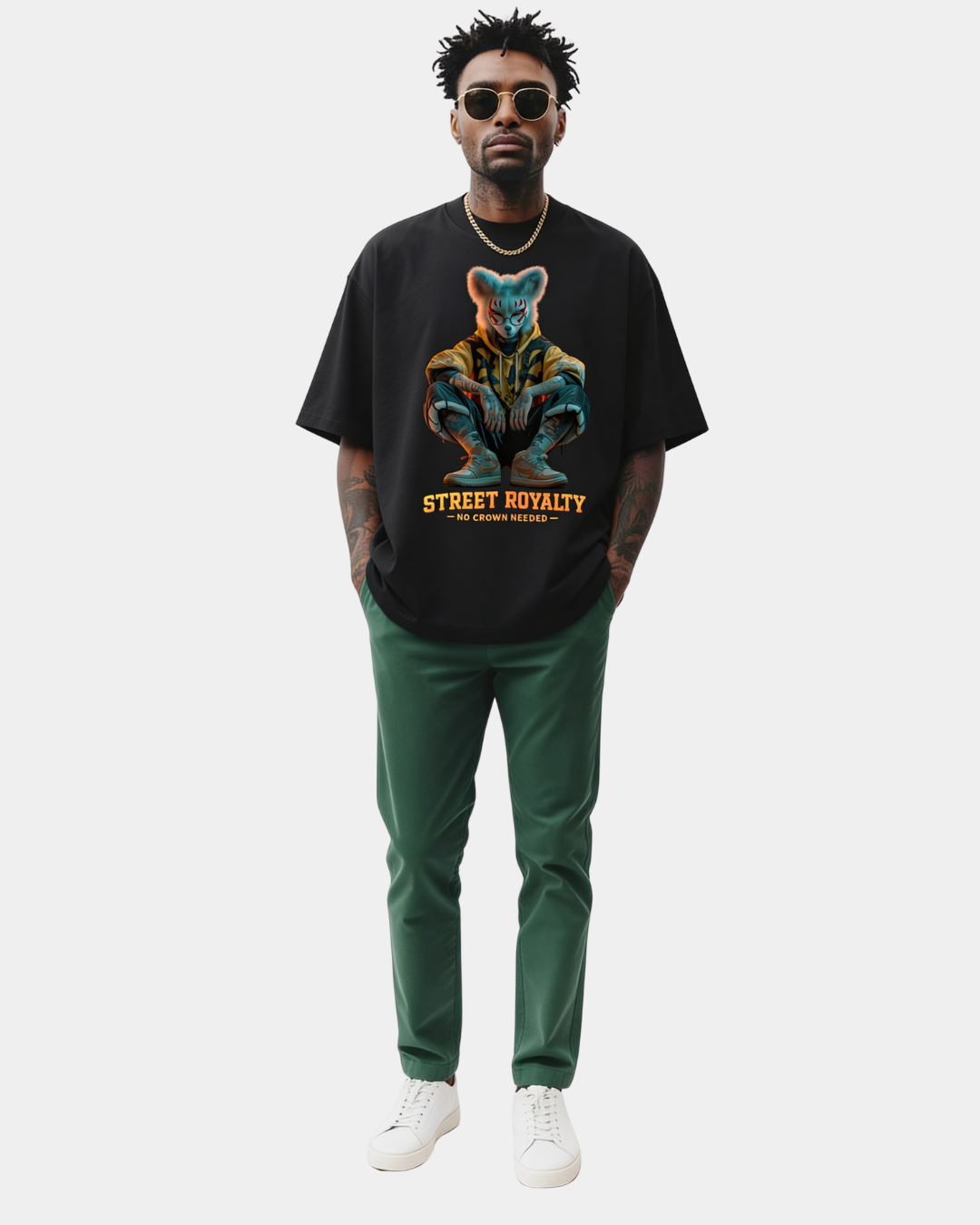 Black oversized streetwear t-shirt with “Street Royalty – No Crown Needed” fox character graphic worn by male model, urban minimalist studio background, modern street fashion.