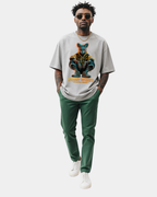 Grey oversized streetwear t-shirt with “Street Royalty – No Crown Needed” graphic worn by male model walking in studio, contemporary urban style, relaxed fit streetwear look.
