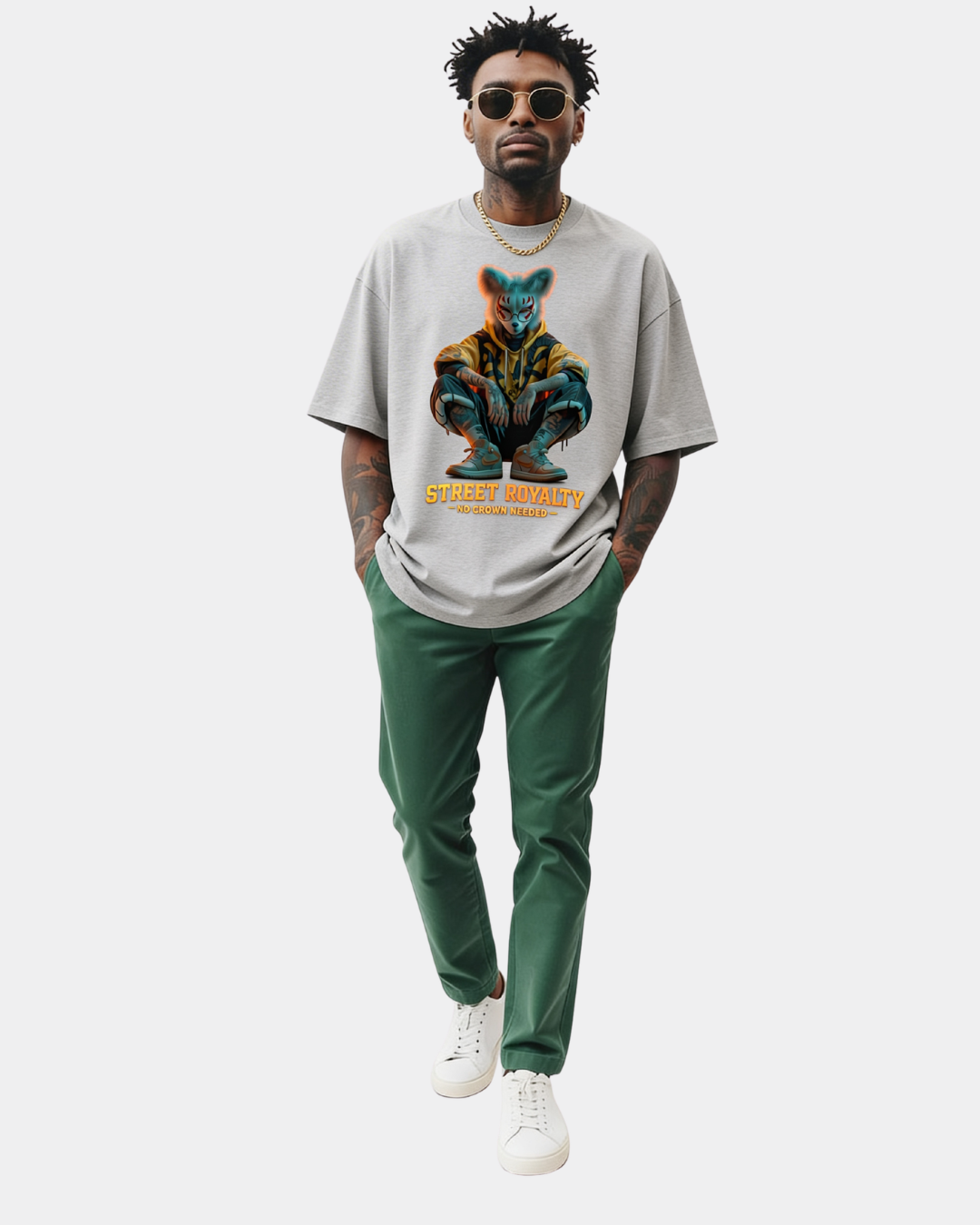 Grey oversized streetwear t-shirt with “Street Royalty – No Crown Needed” graphic worn by male model walking in studio, contemporary urban style, relaxed fit streetwear look.