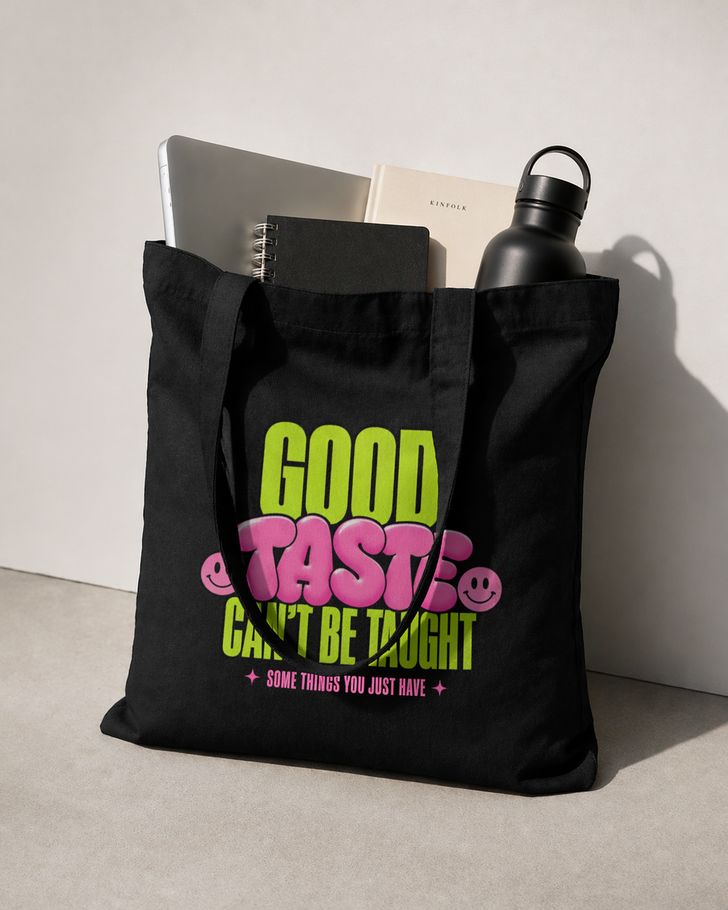 product lifestyle view black tote bag filled with laptop notebook bottle good taste cant be taught graphic streetwear