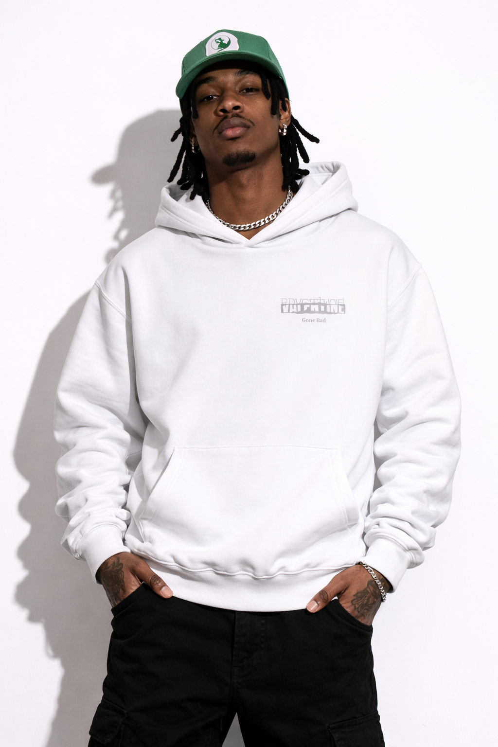 Noiré white oversized streetwear hoodie front view with bold letter Valentine gone bad, worn by male model, urban unisex hoodie.