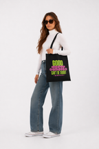 model standing front view wearing oversized black tote bag good taste attitude design graphic streetwear