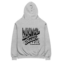 Oversized hoodie in medium grey with "Minimal between basic" graphic typography, back view
