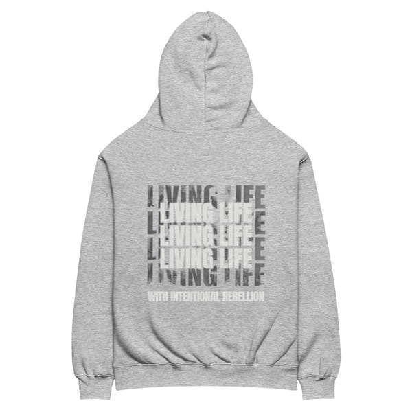 Athletic heather oversized hoodie featuring repeated “Living Life” typography and the phrase “Living life with intentional rebellion” printed on the back.