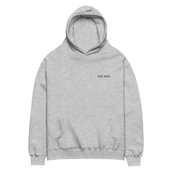 Athletic heather oversized unisex hoodie with minimalist front design, featuring subtle “EST. 2025” text on the chest, clean streetwear style and relaxed fit.