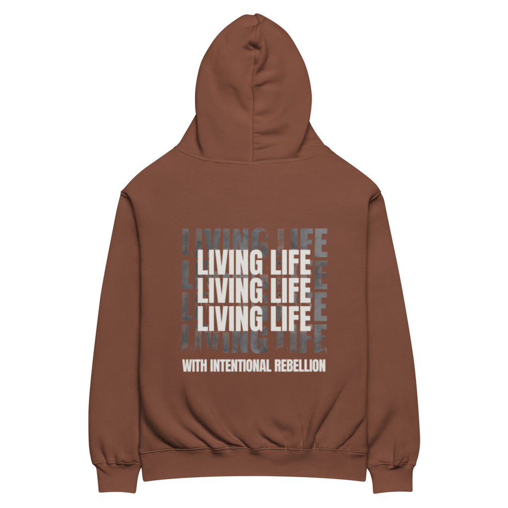 Chestnut oversized hoodie featuring repeated “Living Life” typography and the phrase “Living life with intentional rebellion” printed on the back.