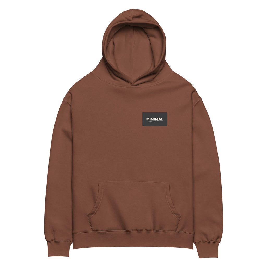 Oversized hoodie in brown with "Minimal But Never Basic" statement typography, front view