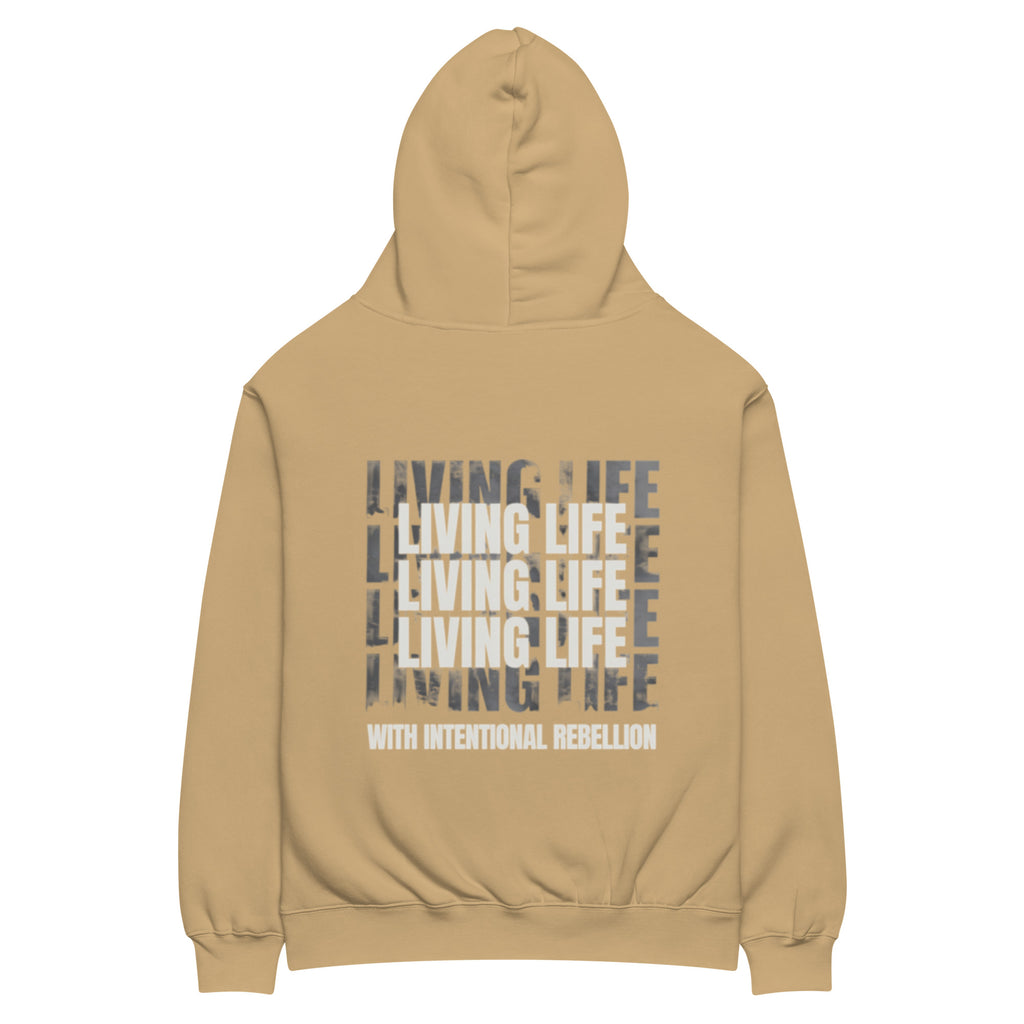 Sand oversized hoodie featuring repeated “Living Life” typography and the phrase “Living life with intentional rebellion” printed on the back.