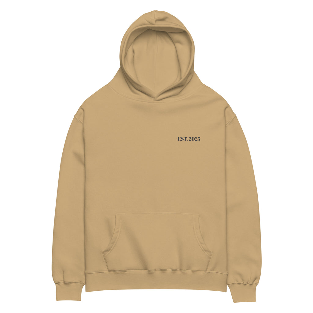 Sand oversized unisex hoodie with minimalist front design, featuring subtle “EST. 2025” text on the chest, clean streetwear style and relaxed fit.