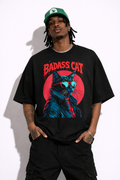 Male model wearing oversized black urban graphic t-shirt with badass cat illustration streetwear design