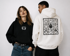 close up editorial couple streetwear hoodie mockup featuring black cropped hoodie front graphic and off white oversized hoodie back graphic urban fashion