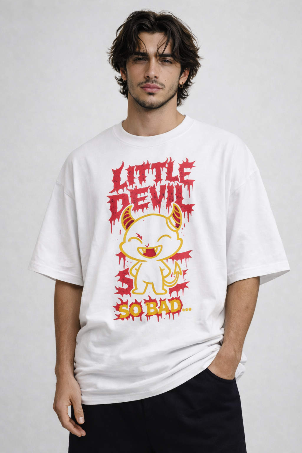 Male model wearing oversized white streetwear graphic t shirt with Little Devil So Bad cartoon character design