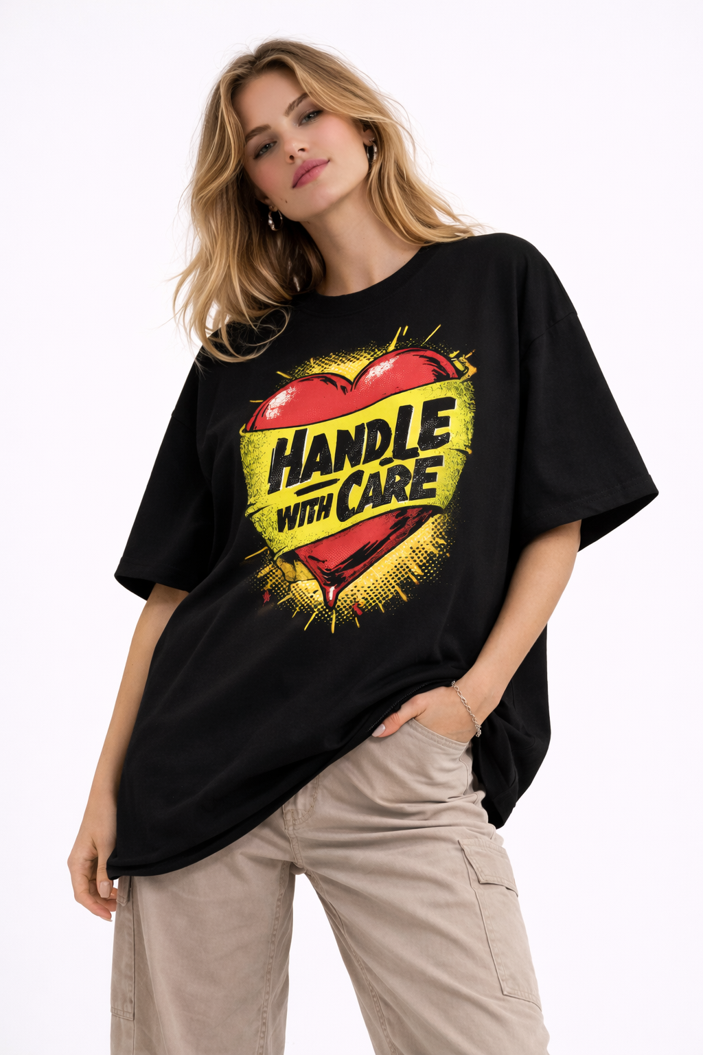 Woman wearing black oversized graphic streetwear t-shirt with Handle With Care heart artwork