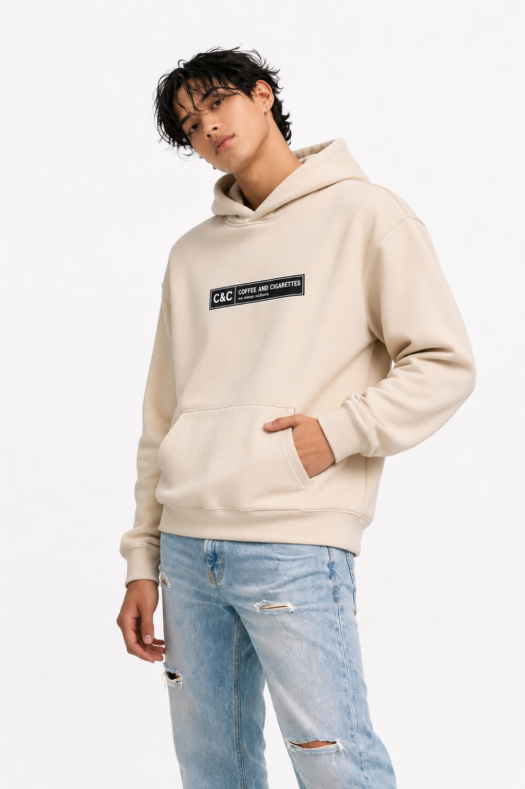 male casual front pose wearing oversized beige graphic streetwear hoodie minimal chest logo urban streetwear outfit
