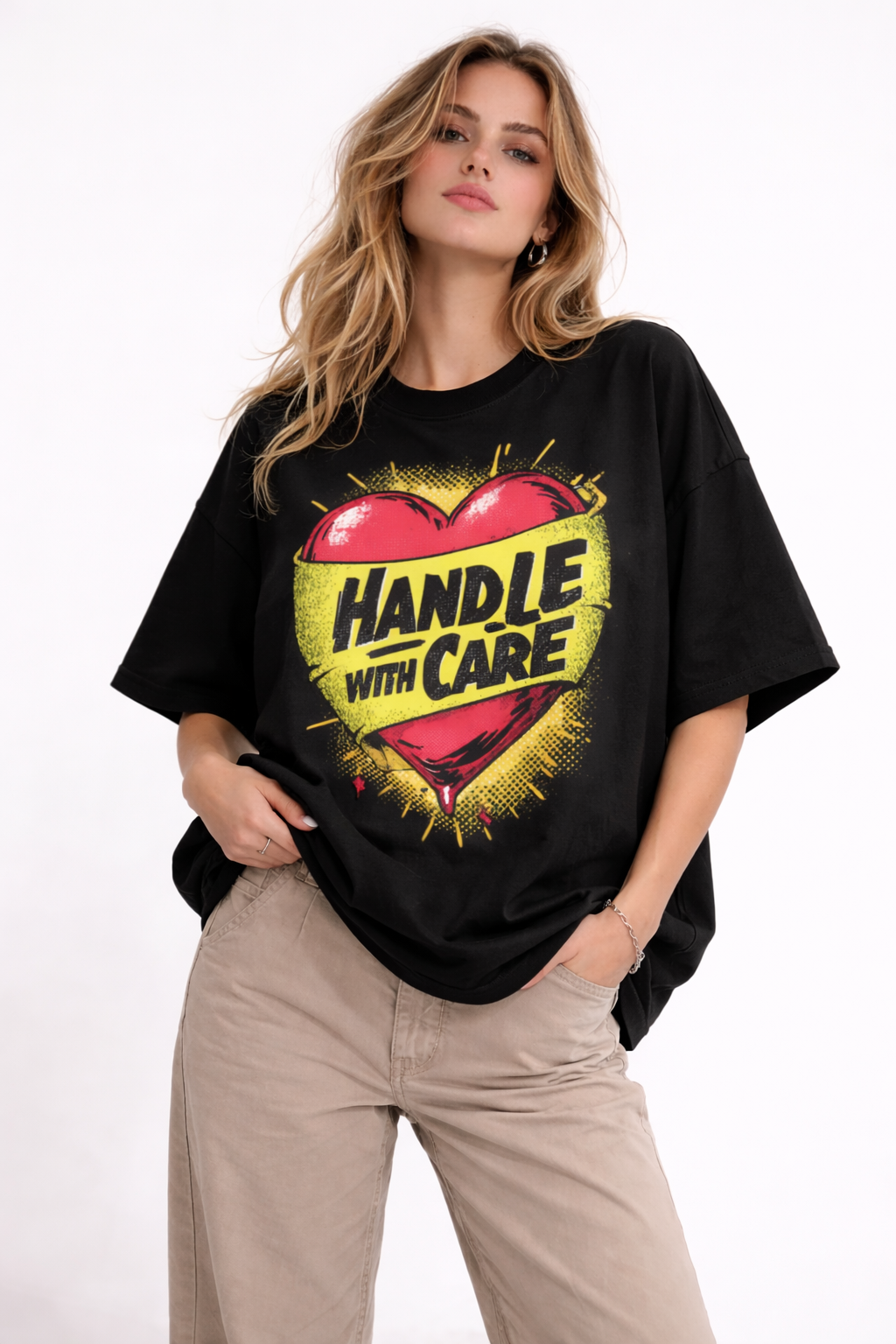 Female  wearing oversized black graphic t-shirt with Handle With Care heart illustration streetwear design