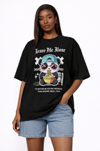 Female model wearing black oversized streetwear graphic t-shirt featuring Leave Me Alone panda noodle illustration