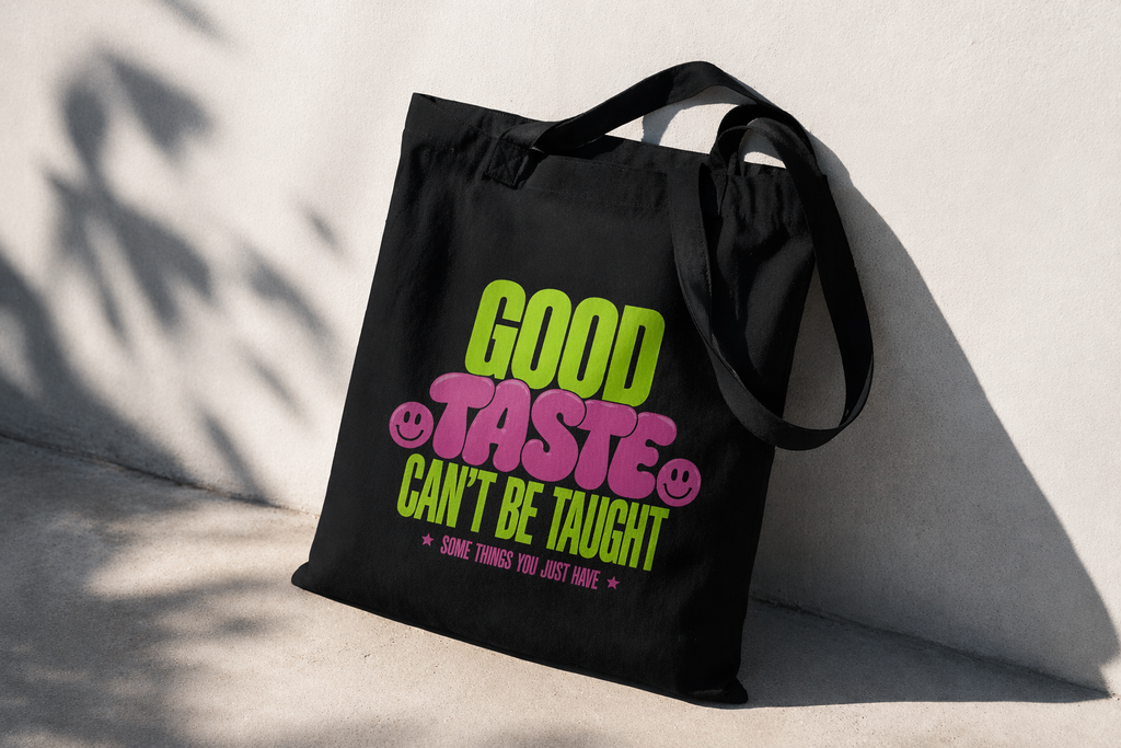 product angled view black tote bag shadow lighting good taste cant be taught typography graphic streetwear