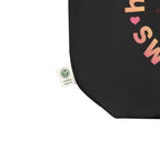 close-up detail black canvas tote bag organic cotton tag fabric texture sustainable streetwear accessory