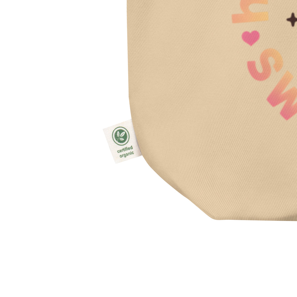 close-up detail beige canvas tote bag organic cotton tag fabric texture sustainable streetwear accessory