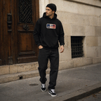 model walking street wearing oversized black hoodie urban outfit paris streetwear fashion