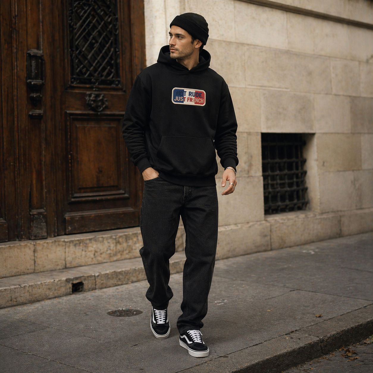 model walking street wearing oversized black hoodie urban outfit paris streetwear fashion