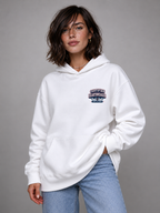 close portrait female model wearing oversized white hoodie with certified heartbreaker chest logo graphic streetwear fashion